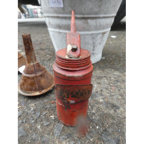 681 - A small vintage bucket and a lot of vintage oil funnels and an oil can.