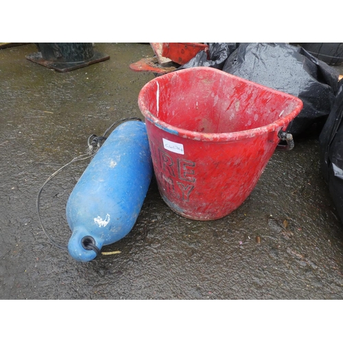 697 - A vintage fire bucket and a fishing buoy.