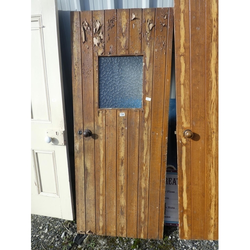 736 - A vintage wooden door with window, measuring 182cm x 75cm x 1cm.