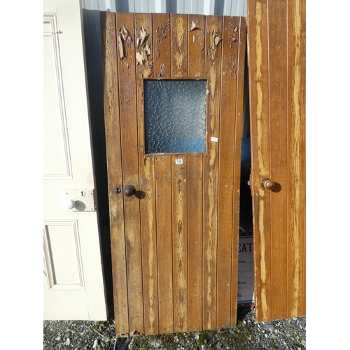 736 - A vintage wooden door with window, measuring 182cm x 75cm x 1cm.