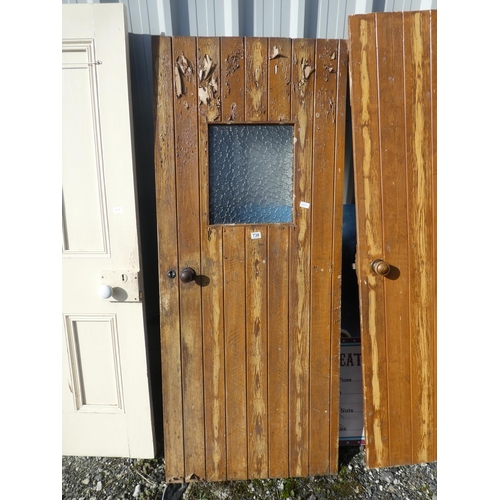 736 - A vintage wooden door with window, measuring 182cm x 75cm x 1cm.