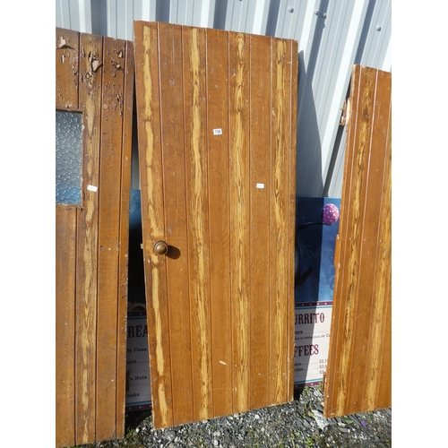 738 - A vintage wooden door, measuring 189cm x 76cm x 2cm.