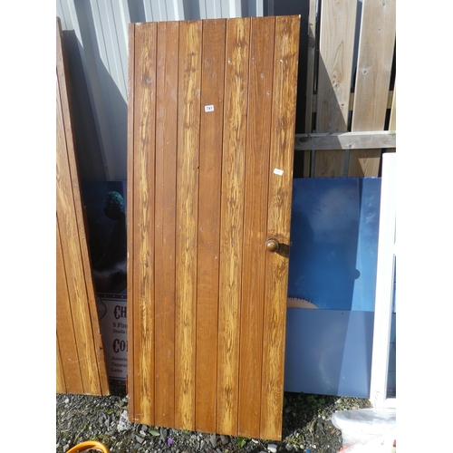 741 - A vintage wooden door, measuring 190cm x 75cm x 2cm.