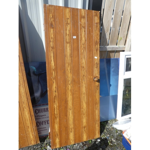 741 - A vintage wooden door, measuring 190cm x 75cm x 2cm.