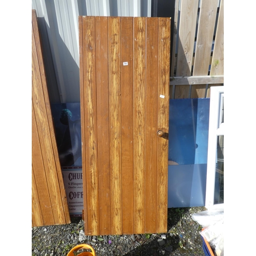 741 - A vintage wooden door, measuring 190cm x 75cm x 2cm.