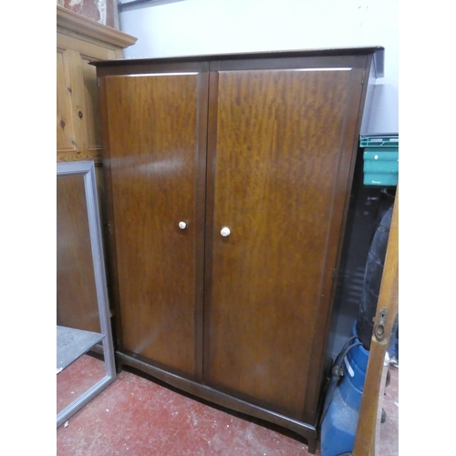 65 - A Stag mahogany two door wardrobe. Approx 70x47x22inches.