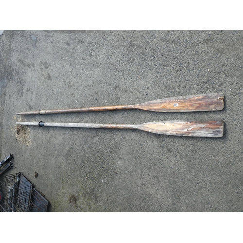 693 - Two large wooden oars.  Approx 300cm long.