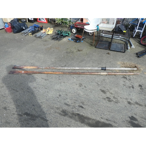 693 - Two large wooden oars.  Approx 300cm long.