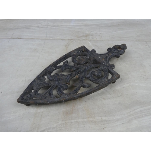 23 - A vintage cast iron trivet.