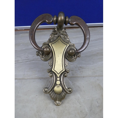 55 - A decorative brass door knocker.