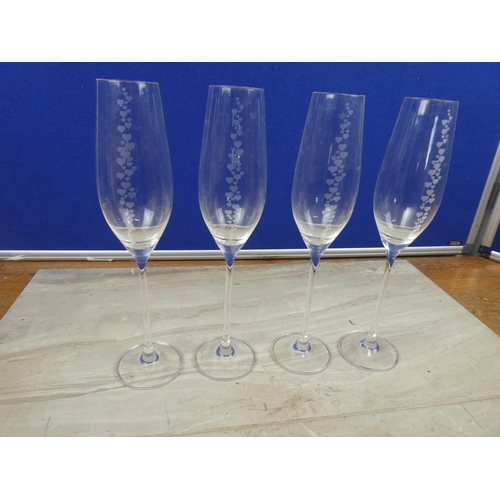 72 - Four Dartington champagne flutes decorated with heart design.