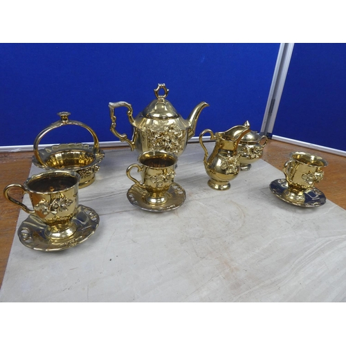 77 - A ceramic pottery coffee set with gilt detail.