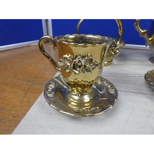 77 - A ceramic pottery coffee set with gilt detail.