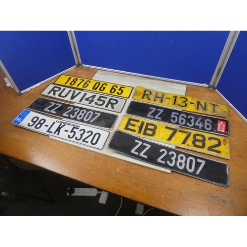 85 - An assortment of various number plates.