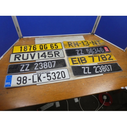 85 - An assortment of various number plates.