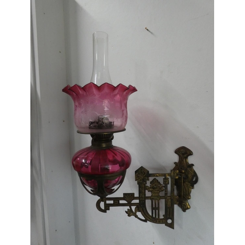 200 - A stunning pair of ruby glass oil lamps with gilt metal wall brackets & decorative glass shades. (1 ... 