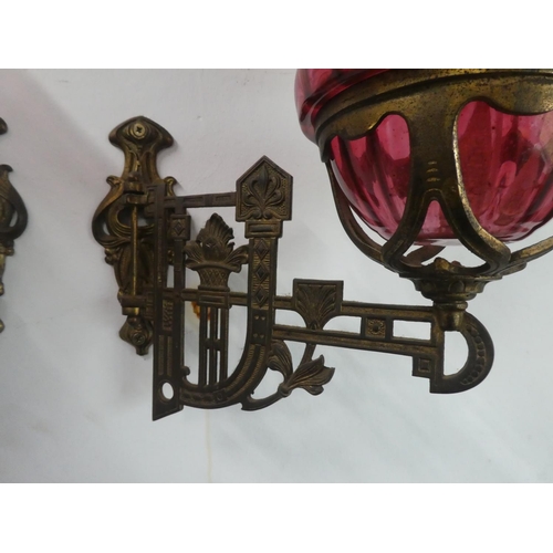 200 - A stunning pair of ruby glass oil lamps with gilt metal wall brackets & decorative glass shades. (1 ... 