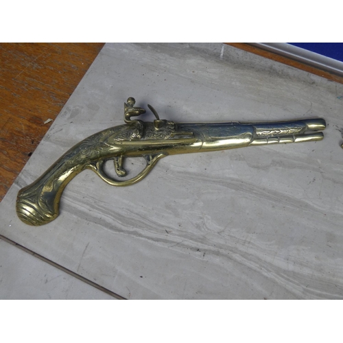 206 - A pair of vintage brass pistol wall plaques.