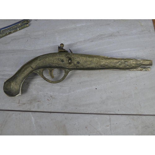 206 - A pair of vintage brass pistol wall plaques.