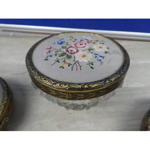 209 - A pair of gilt metal candlesticks with handstitched floral detail and a matching lidded trinket dish... 