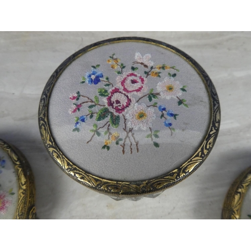 209 - A pair of gilt metal candlesticks with handstitched floral detail and a matching lidded trinket dish... 