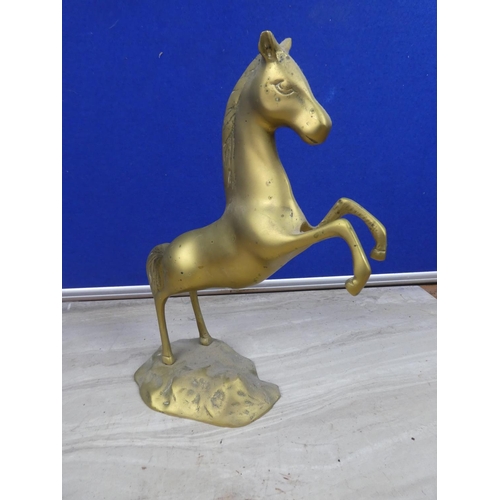 218 - A rearing brass horse ornament.  Approx 20cm.