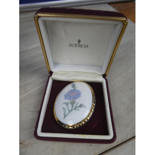 229 - A Belleek Donegal pottery brooch and more.