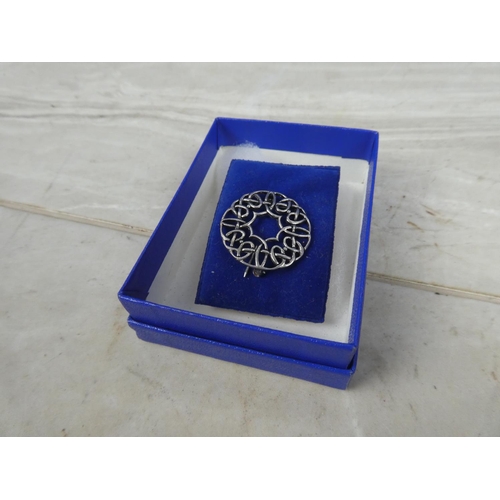 242 - A boxed sterling silver celtic design brooch.