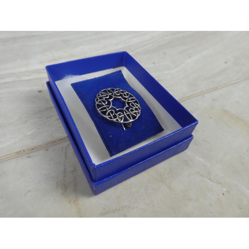 242 - A boxed sterling silver celtic design brooch.