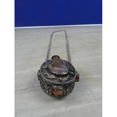 250 - A silver metal snuff box covered in gemstones on a silver metal chain.