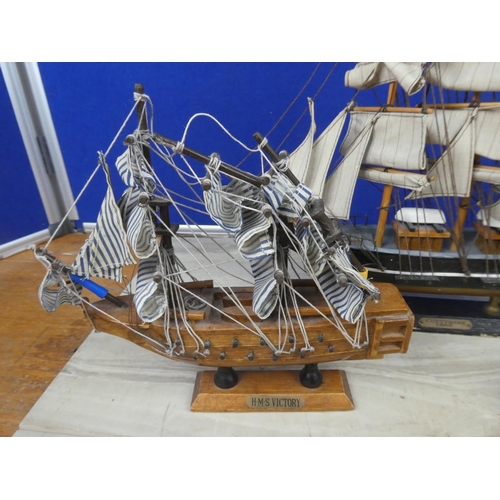 259 - A Cuttysark model boat and two others.  Tallest approx 30cm.