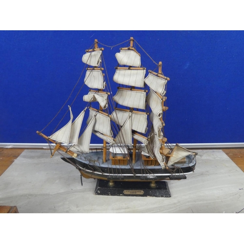 259 - A Cuttysark model boat and two others.  Tallest approx 30cm.