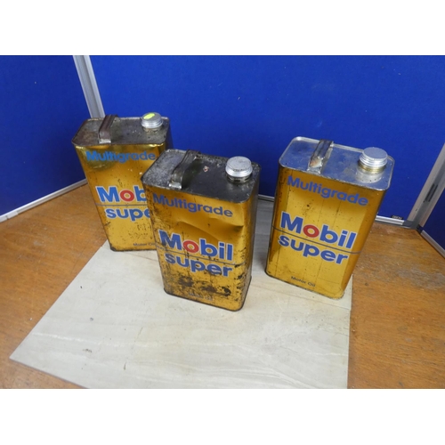 344 - Two Mobil Super oil cans and contents and another empty can.