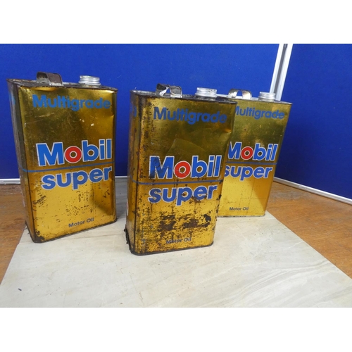 344 - Two Mobil Super oil cans and contents and another empty can.