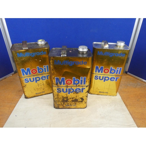 344 - Two Mobil Super oil cans and contents and another empty can.