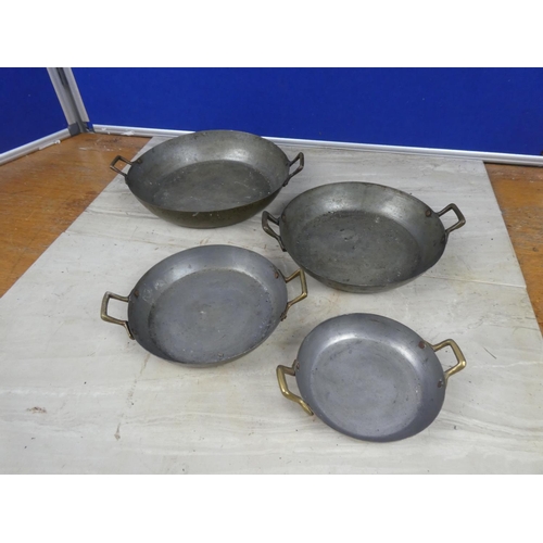 360 - A set of four brass pans.