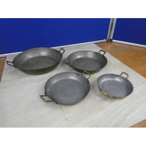 360 - A set of four brass pans.