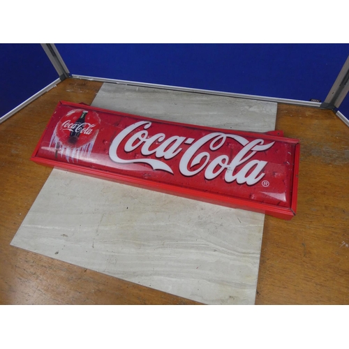 370 - A vintage Coca Cola plastic sign on a metal frame.  Approx 71x22cm.