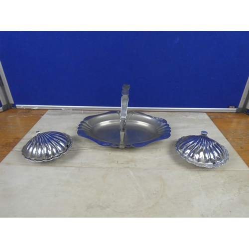 314 - A vintage silver plated swing handle serving dish and two shell shaped silver plate and glass butter... 