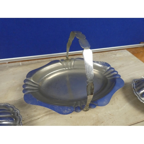 314 - A vintage silver plated swing handle serving dish and two shell shaped silver plate and glass butter... 