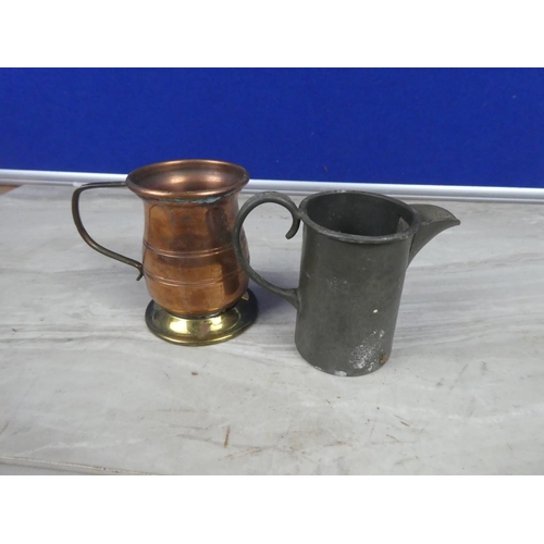 322 - An antique Sheffield hand hammered pewter jug and another copper and brass jug,