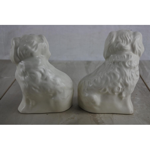 103 - A pair of antique Staffordshire spaniel mantle dogs.  Approx 15cm.