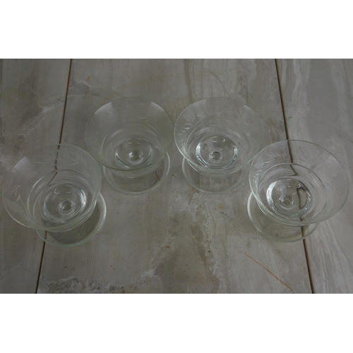 130 - A set of four etched glass sundae dishes.