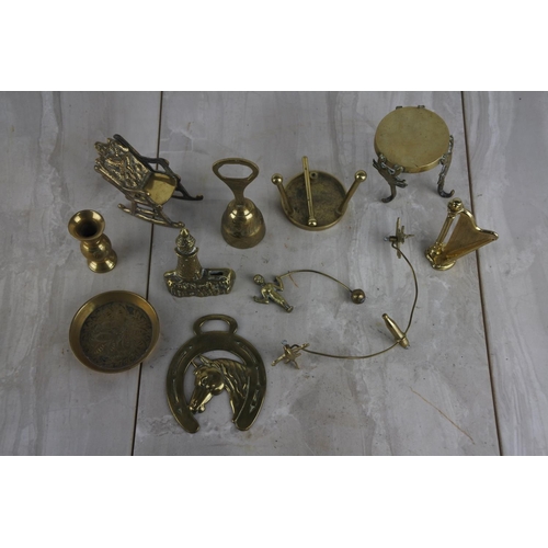 136 - A large collection of small brass ware items to include a rocking chair, a harp and more.