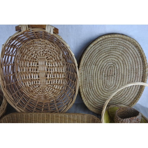 156 - A large lot of wicker and rattan baskets and trays and more.