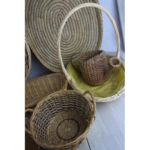 156 - A large lot of wicker and rattan baskets and trays and more.