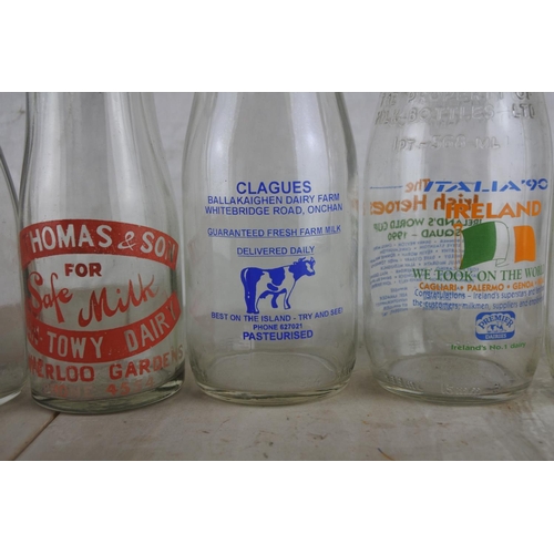 171 - A collection of vintage milk bottles.