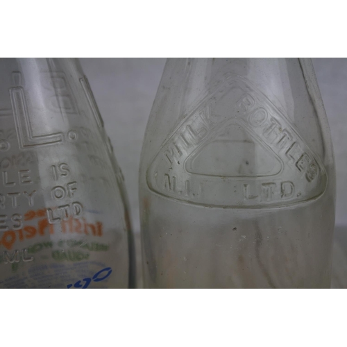 171 - A collection of vintage milk bottles.