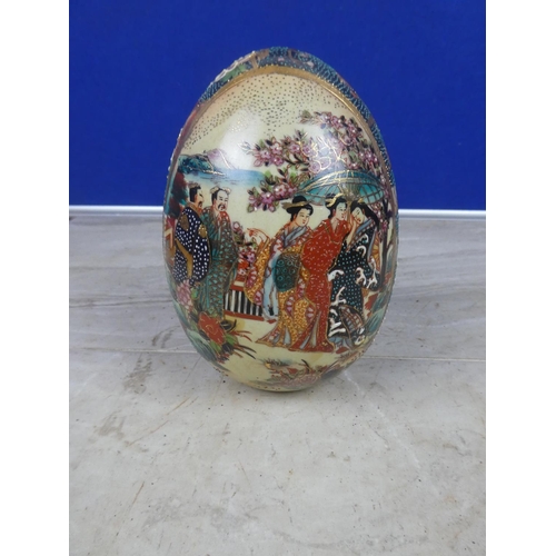 404 - An oriental patterned ceramic egg ornament.