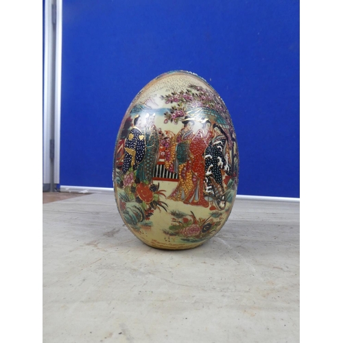 404 - An oriental patterned ceramic egg ornament.